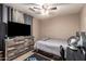 Bedroom with a sleek wood dresser, flat screen tv, and comfortable sleeping space at 605 S Monterey St, Gilbert, AZ 85233