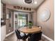Cozy breakfast nook with a round wood table, modern decor, and sliding glass doors to the pool at 605 S Monterey St, Gilbert, AZ 85233