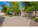 Charming home featuring a well-maintained lawn, mature trees, and a spacious two-car garage, enhancing curb appeal at 605 S Monterey St, Gilbert, AZ 85233
