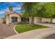 Inviting home featuring lush green grass, well-manicured landscaping, and a neatly paved walkway, enhancing curb appeal at 605 S Monterey St, Gilbert, AZ 85233