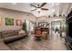 Cozy living room with wood-look tile flooring, neutral decor, and an open layout, ideal for entertaining guests at 605 S Monterey St, Gilbert, AZ 85233
