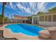 Inviting backyard pool with rock features and covered outdoor space for entertaining at 605 S Monterey St, Gilbert, AZ 85233