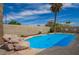 Sparkling private pool with natural rock features and a meticulously maintained deck at 605 S Monterey St, Gilbert, AZ 85233