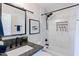 Elegant bathroom with marble tile, black fixtures, and a built-in shower niche at 6413 E Parkview Dr, Scottsdale, AZ 85257
