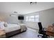 Bright bedroom featuring a queen-size bed, desk, and a large window overlooking the backyard at 6413 E Parkview Dr, Scottsdale, AZ 85257