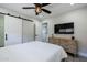 Bright bedroom features a ceiling fan and a wooden dresser for storage at 6413 E Parkview Dr, Scottsdale, AZ 85257