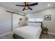 Bright bedroom features a ceiling fan, sliding closet door, and neutral color scheme at 6413 E Parkview Dr, Scottsdale, AZ 85257