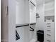 Spacious closet with white shelving, hanging rods, and a designated space for a laundry basket at 6413 E Parkview Dr, Scottsdale, AZ 85257