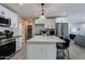 Well-lit kitchen featuring white cabinets, stainless steel appliances, and a large island with bar seating at 6413 E Parkview Dr, Scottsdale, AZ 85257