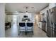 Stylish kitchen with white cabinets, stainless steel appliances, an island with bar stools, and nice tile floors at 6413 E Parkview Dr, Scottsdale, AZ 85257