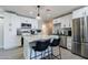 Bright kitchen featuring white cabinets, stainless steel appliances, and a spacious island with seating at 6413 E Parkview Dr, Scottsdale, AZ 85257