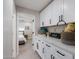 Well-organized laundry room with white cabinets, countertop space, and convenient access to bedroom at 6413 E Parkview Dr, Scottsdale, AZ 85257