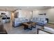 Open-concept living room featuring modern furniture, a wooden coffee table, and access to the kitchen at 6413 E Parkview Dr, Scottsdale, AZ 85257