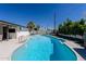 Beautiful in-ground pool surrounded by a well-maintained patio and lush landscaping at 6413 E Parkview Dr, Scottsdale, AZ 85257
