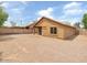 Wide shot of the property's expansive gravel backyard, enclosed by a block wall at 7037 W Cavalier Dr, Glendale, AZ 85303