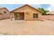 Large, gravel backyard with a covered patio that provides shade at 7037 W Cavalier Dr, Glendale, AZ 85303