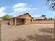 Gravel backyard area with covered patio and block wall surrounding the property at 7037 W Cavalier Dr, Glendale, AZ 85303