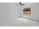 A well-lit bedroom features a ceiling fan and a view of the backyard at 7037 W Cavalier Dr, Glendale, AZ 85303
