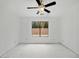 A ceiling fan adds comfort to this bedroom with a backyard view at 7037 W Cavalier Dr, Glendale, AZ 85303