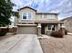 Charming two-story home with a two-car garage, stone accents, and desert landscaping for curb appeal at 7258 W State Ave, Glendale, AZ 85303