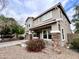 Charming two-story home featuring desert landscaping, a covered porch and stone-accented columns at 7258 W State Ave, Glendale, AZ 85303