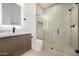 Modern bathroom features black shower and sink fixtures with wood cabinets at 8549 E Indianola Ave, Scottsdale, AZ 85251