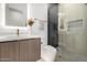 Modern bathroom featuring a glass-enclosed shower with unique tiling and a vanity with a backlit mirror at 8549 E Indianola Ave, Scottsdale, AZ 85251