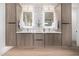 Modern bathroom with dual vanities, designer mirrors, and stylish wood cabinets at 8549 E Indianola Ave, Scottsdale, AZ 85251