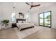 Bright bedroom with tile floor, modern ceiling fan, and access to backyard at 8549 E Indianola Ave, Scottsdale, AZ 85251