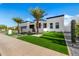 Modern home showcasing sleek architecture, well-manicured turf, and stylish desert landscaping at 8549 E Indianola Ave, Scottsdale, AZ 85251
