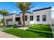 Stunning home displaying a manicured lawn, desert landscaping and a sleek modern design at 8549 E Indianola Ave, Scottsdale, AZ 85251