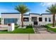Stunning modern home with a landscaped front yard, walkway lighting, and a gated entrance at 8549 E Indianola Ave, Scottsdale, AZ 85251