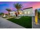 Modern home features a manicured lawn, stylish landscaping, and a sleek architectural design at 8549 E Indianola Ave, Scottsdale, AZ 85251
