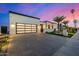 Modern home showcasing clean lines, a spacious driveway, and desert landscaping at 8549 E Indianola Ave, Scottsdale, AZ 85251