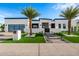 Stunning modern home with a landscaped front yard, walkway lighting, and a gated entrance at 8549 E Indianola Ave, Scottsdale, AZ 85251