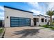 A contemporary home shows off its sleek glass garage door and modern architectural design at 8549 E Indianola Ave, Scottsdale, AZ 85251
