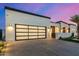 Sleek modern home featuring a contemporary glass garage door and minimalist design at 8549 E Indianola Ave, Scottsdale, AZ 85251