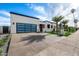 Contemporary home with a striking glass-paneled garage door and modern landscaping at 8549 E Indianola Ave, Scottsdale, AZ 85251