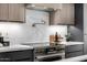 Gourmet kitchen showcases a stainless steel range, hood, and pot filler faucet at 8549 E Indianola Ave, Scottsdale, AZ 85251