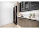 Kitchen featuring modern cabinetry, wine fridge, stone countertops, and decor at 8549 E Indianola Ave, Scottsdale, AZ 85251