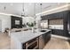 Modern kitchen with a large island, stainless steel appliances, sleek cabinetry, and stylish finishes at 8549 E Indianola Ave, Scottsdale, AZ 85251