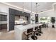 Modern kitchen features a large island, sleek cabinetry, pendant lighting, and open dining area at 8549 E Indianola Ave, Scottsdale, AZ 85251
