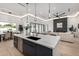Modern kitchen with large island, sleek cabinets, and stainless steel appliances, flowing into the living space at 8549 E Indianola Ave, Scottsdale, AZ 85251