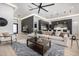 Open-concept living room boasts stylish decor, large sectional sofa, and modern fixtures with seamless flow to kitchen at 8549 E Indianola Ave, Scottsdale, AZ 85251