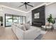 Bright living room featuring a linear fireplace, modern furnishings, and a view of the outdoors at 8549 E Indianola Ave, Scottsdale, AZ 85251