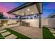 Outdoor kitchen with grill, refrigeration and custom pergola in a modern-style backyard at 8549 E Indianola Ave, Scottsdale, AZ 85251
