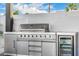 Stainless steel outdoor kitchen with grill, storage, and beverage fridge for ultimate outdoor entertainment at 8549 E Indianola Ave, Scottsdale, AZ 85251