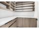 Walk-in pantry features modern cabinets and shelving for ample storage at 8549 E Indianola Ave, Scottsdale, AZ 85251