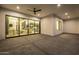 Outdoor patio featuring a ceiling fan, concrete floors, and a view through sliding doors into the home at 8549 E Indianola Ave, Scottsdale, AZ 85251
