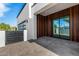 Exterior view of the patio, featuring sleek wood accents and a modern glass-paneled garage door at 8549 E Indianola Ave, Scottsdale, AZ 85251